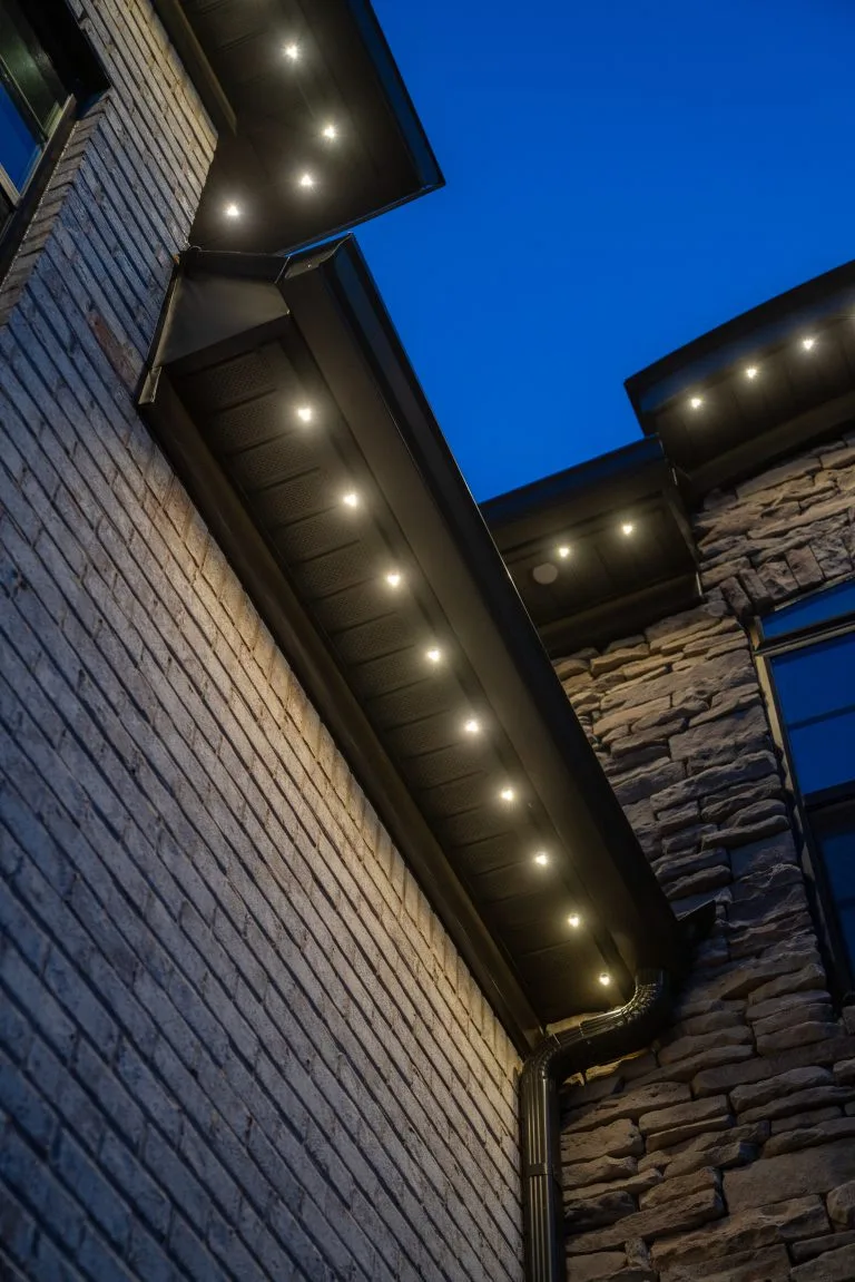 Warm lights illuminate the sleek architecture against a deep blue twilight sky