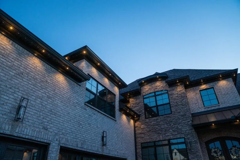 A modern house features elegant lighting against a twilight sky
