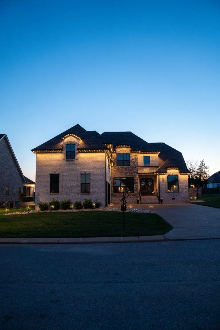 A beautifully lit house stands out against a dusk sky