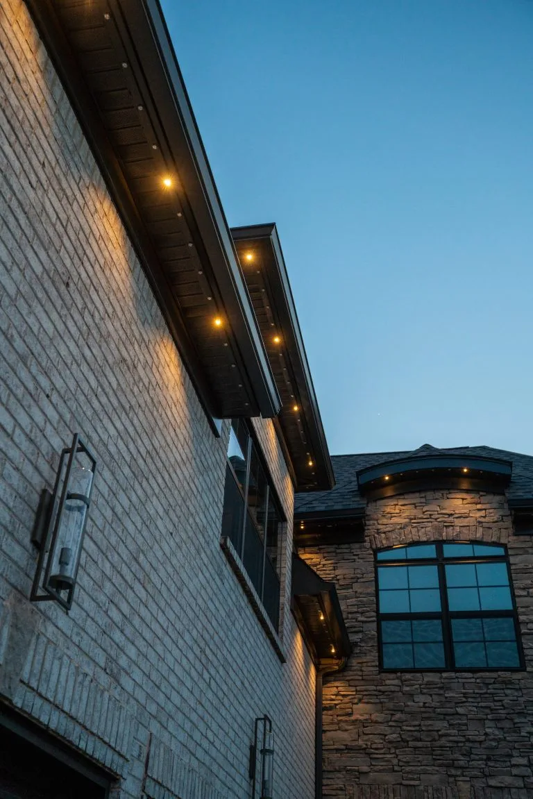 Warm lights illuminate a brick exterior against a twilight sky