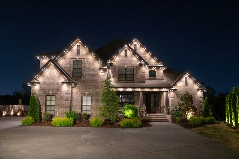 A beautifully illuminated house adorned with festive lights during a night scene