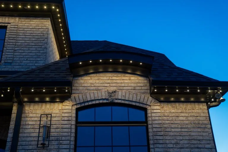 Warm lights elegantly outline a sophisticated building against a twilight sky