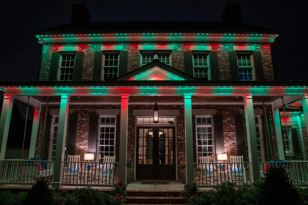 Nashville TN house decorated with red and green lights for a festive night ambiance