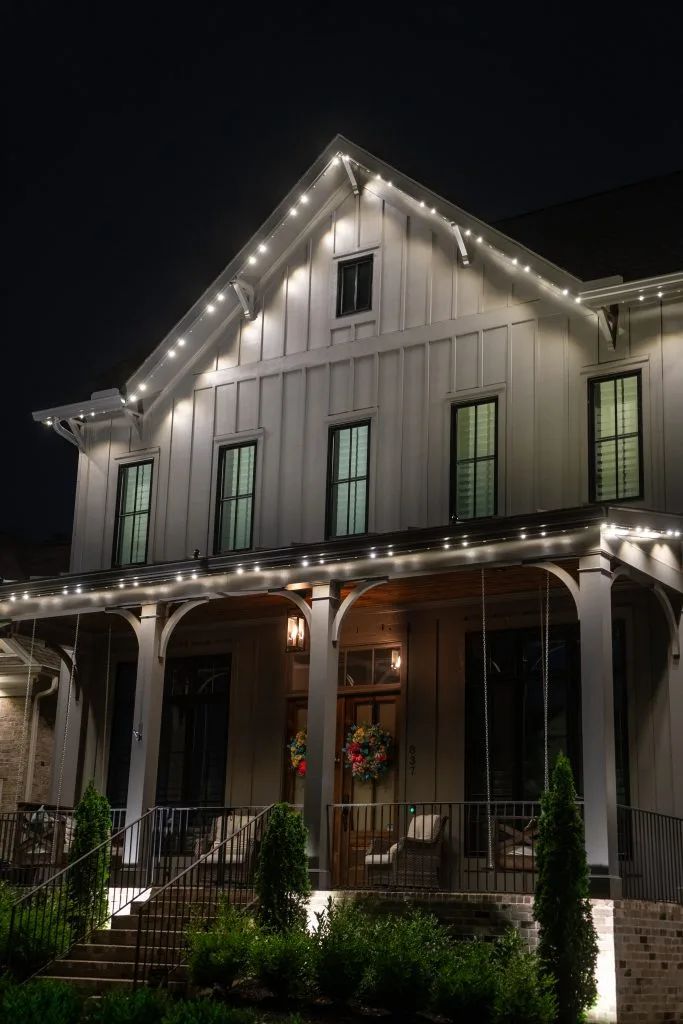 Soffit & under-eave lighting enhances a charming house near Green Hills, Tennessee, creating a warm nighttime glow