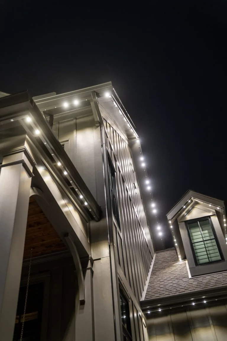 Soft lights accentuate the architectural details of a modern house at night