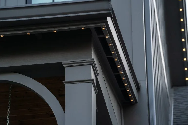 Warm lights are elegantly installed along the architectural trim of a building