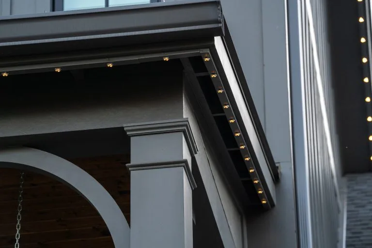 Warm lights illuminate the architectural details of a modern building exterior