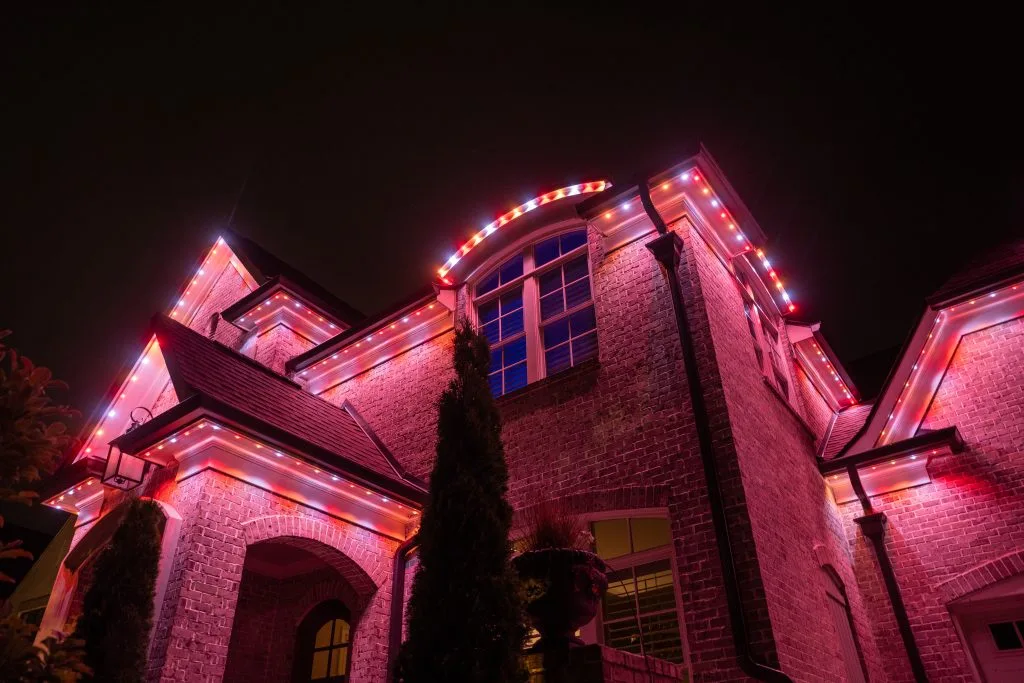 Soffit & under-eave lighting near Ansley Park Atlanta enhances the home's vibrant colors at night