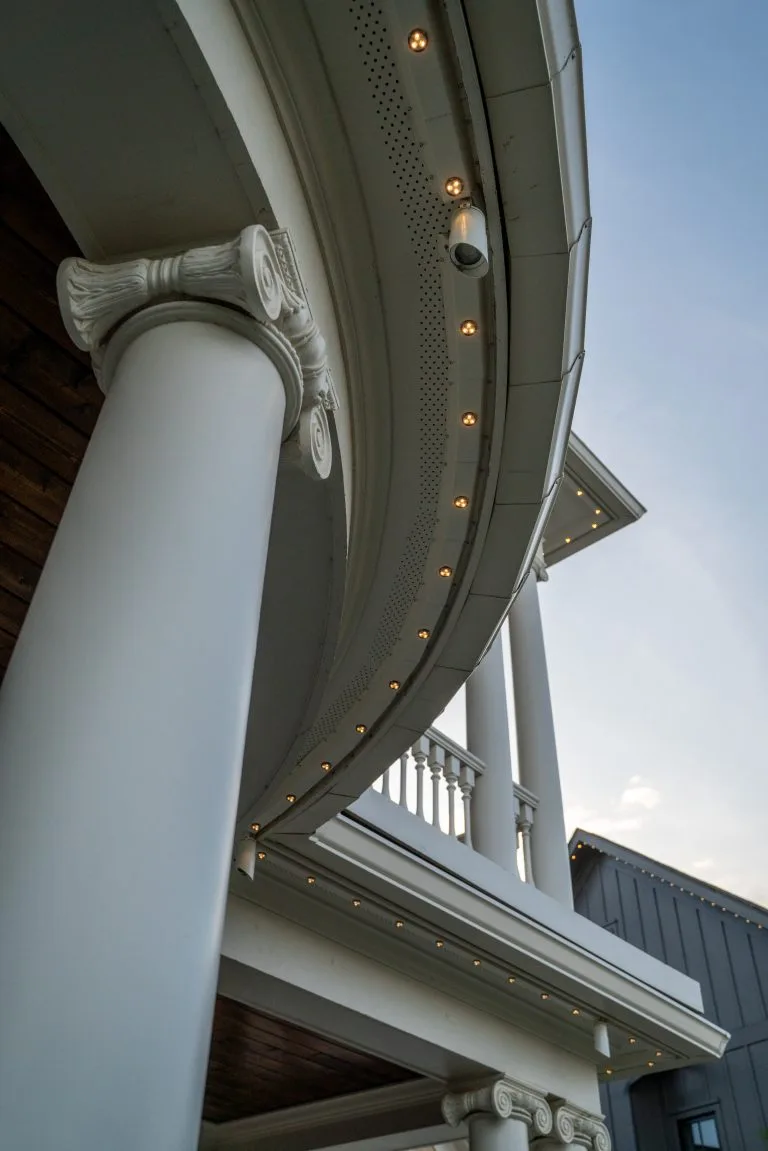 Curved architecture features elegant columns and subtle lighting against a twilight sky