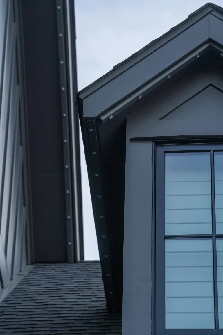 A close-up view of a modern building's roofline and window details