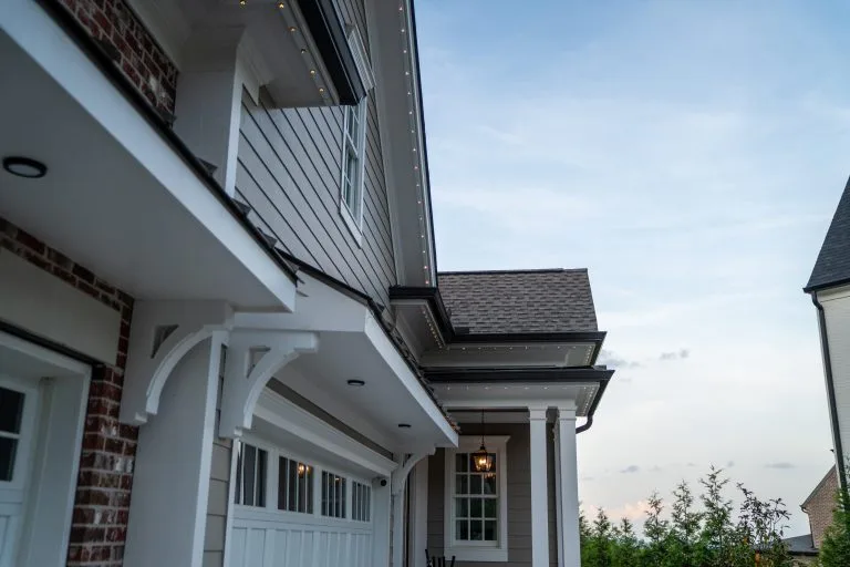 A modern home showcases a stylish exterior with a garage and careful architectural details