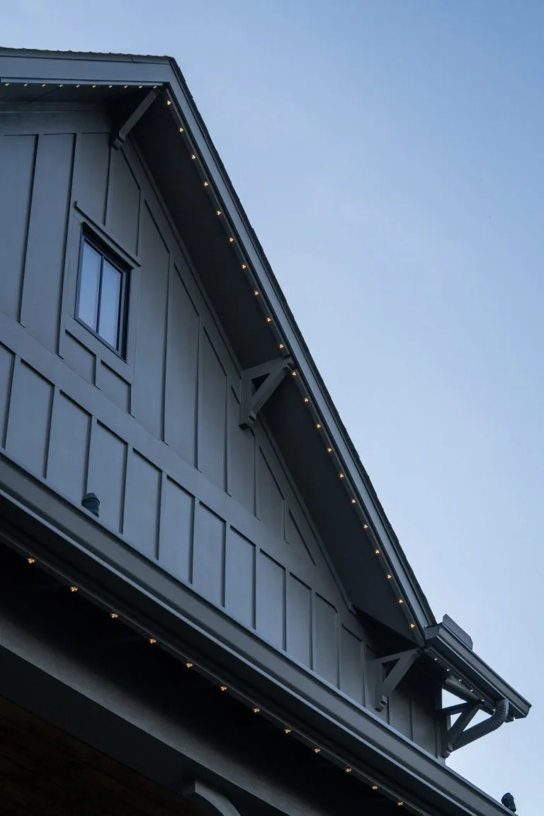 A sleek, modern rooftop is adorned with soft, glowing lights against a clear sky