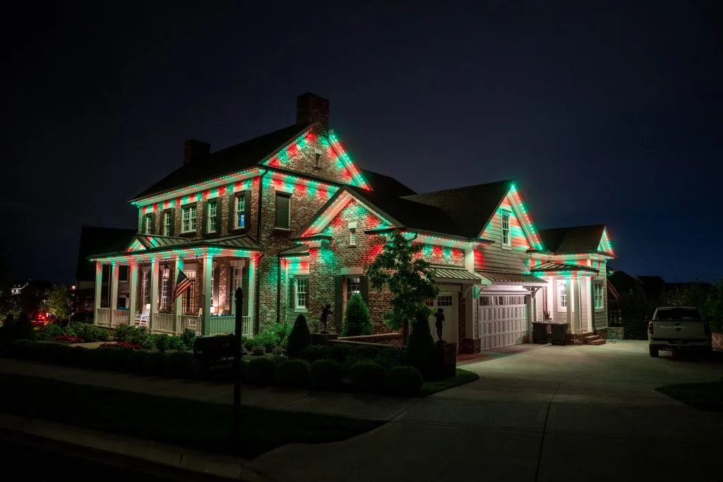 Knoxville TN house illuminated with festive red and green lights at night