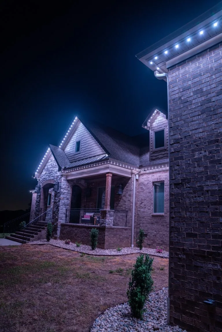 A beautifully illuminated house stands out against the night sky