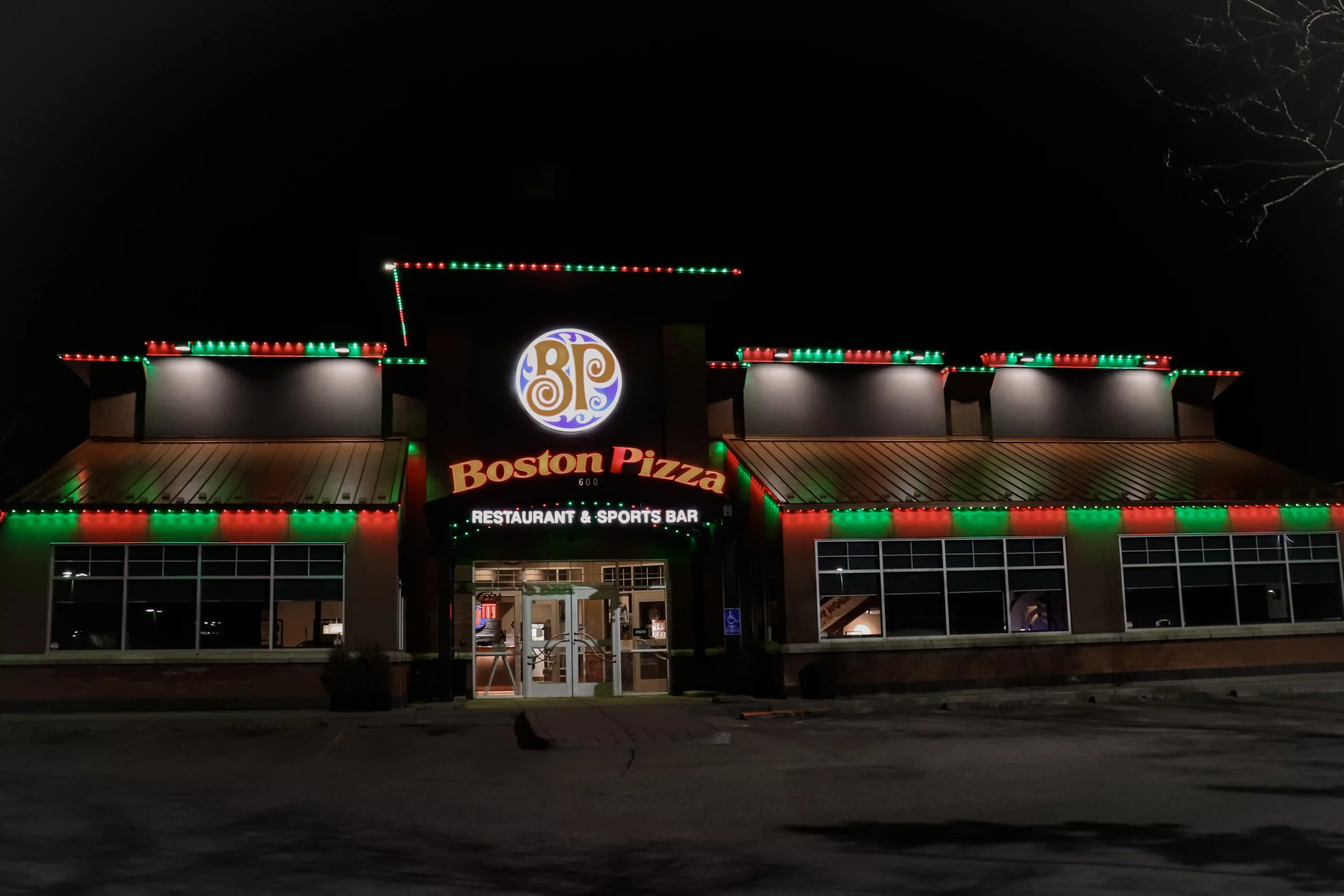 Commercial Christmas Lights Installation Knoxville on a large retail storefront building, highlighting rooflines and windows with bright LED lighting.